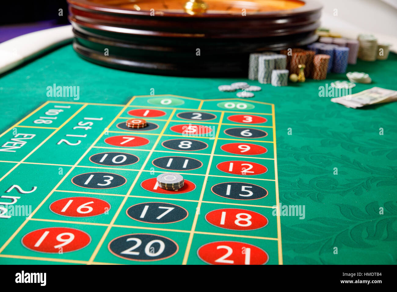 Casino Roulette Wheel With Casino Chips On Green Table. Gambling  Background. 3d Illustration Stock Photo, Picture and Royalty Free Image.  Image 80169656.