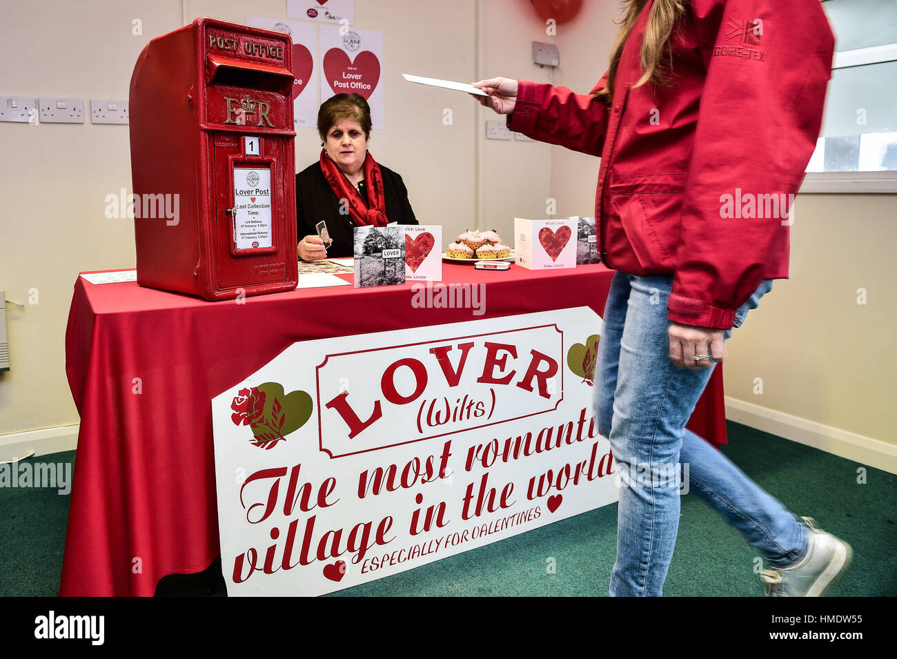 a woman posts a valentines day card in the pop up post office valentines day cards