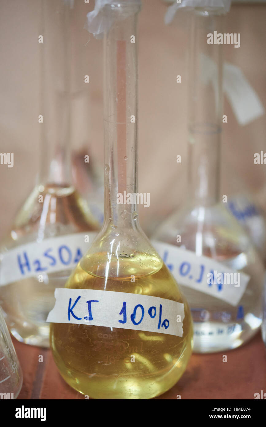 chemical yellow reagents in glass flask lab Stock Photo