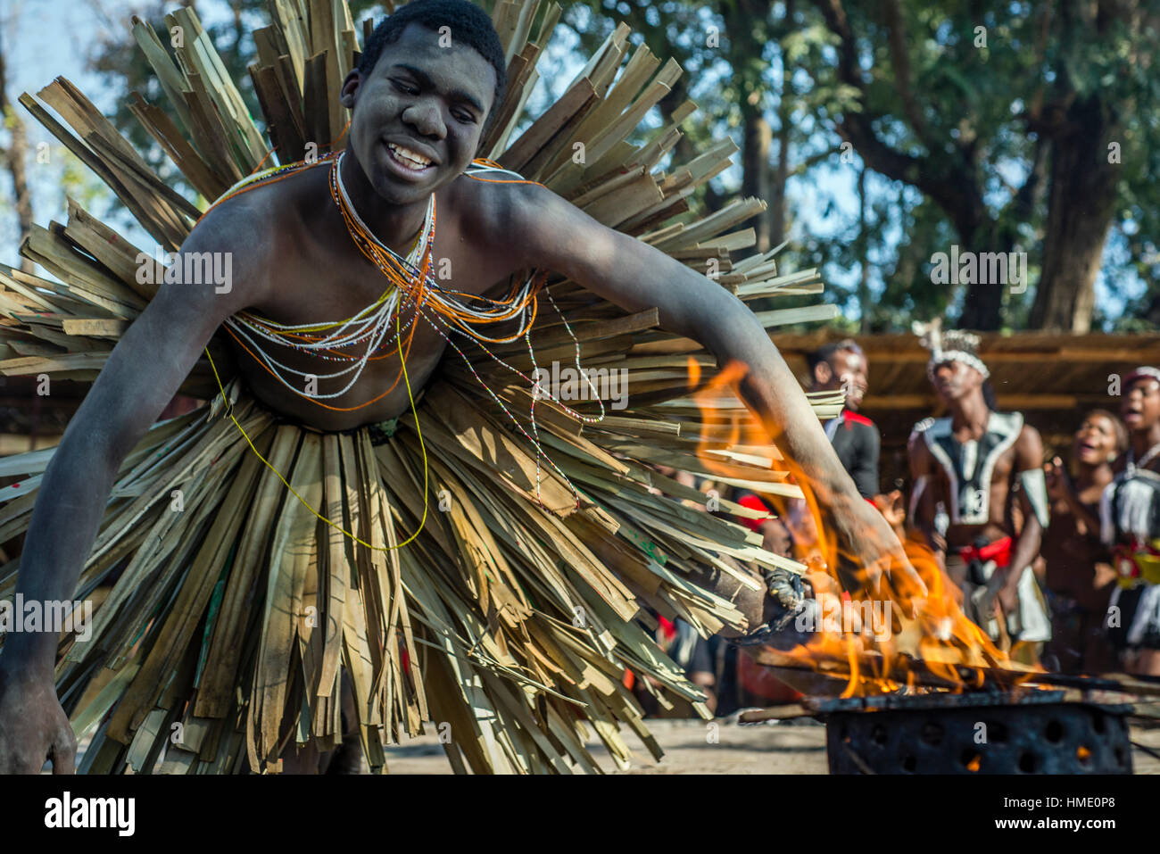 A young man performs traditional dance with fire at Zambia