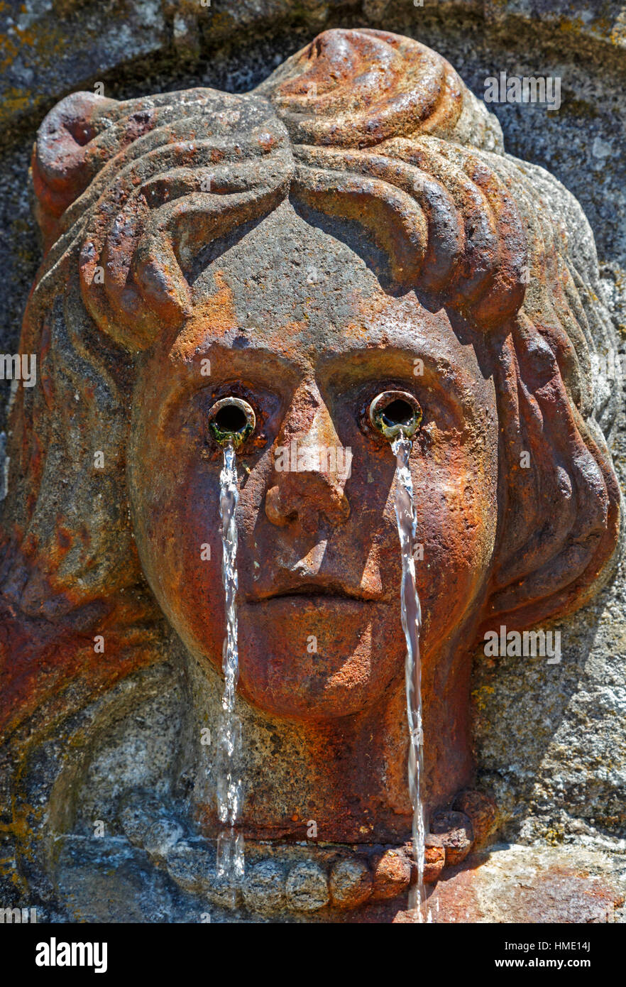 Braga, Braga District, Portugal.  Bom Jesus do Monte sanctuary.  Face of crying woman on fountain on the Baroque staircase. Stock Photo