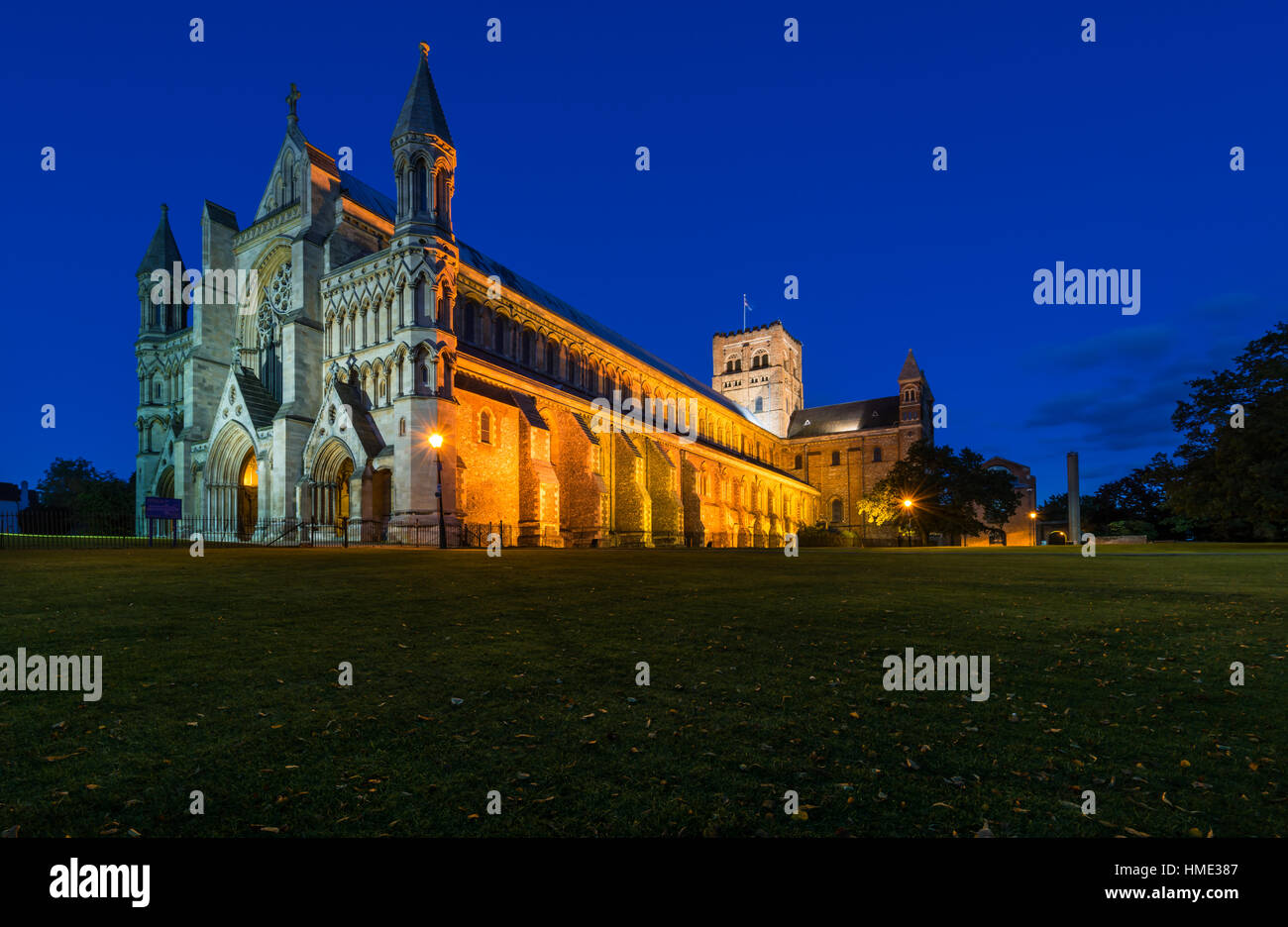 Side view of lit up St Albans Cathedral (St Albans, Hertfordshire) during evening blue hour Stock Photo