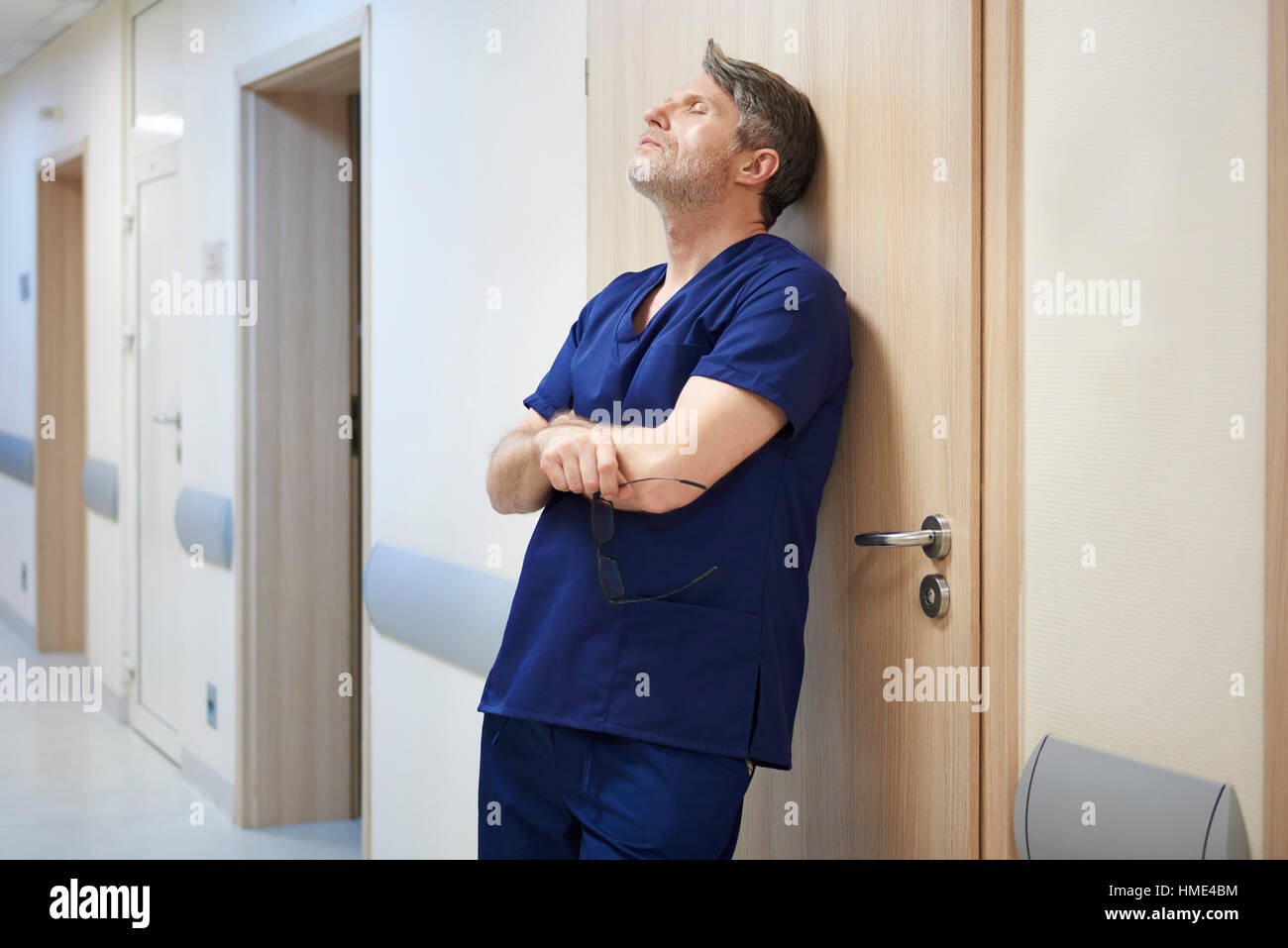 Worried tired doctor standing hi-res stock photography and images - Alamy