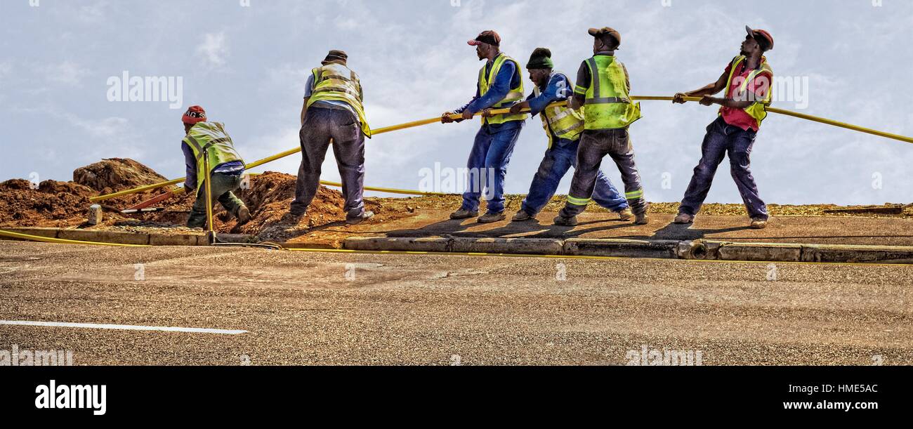A team of men working. Pulling through fibre optic cable connection. Cape  Town, South Africa Stock Photo - Alamy