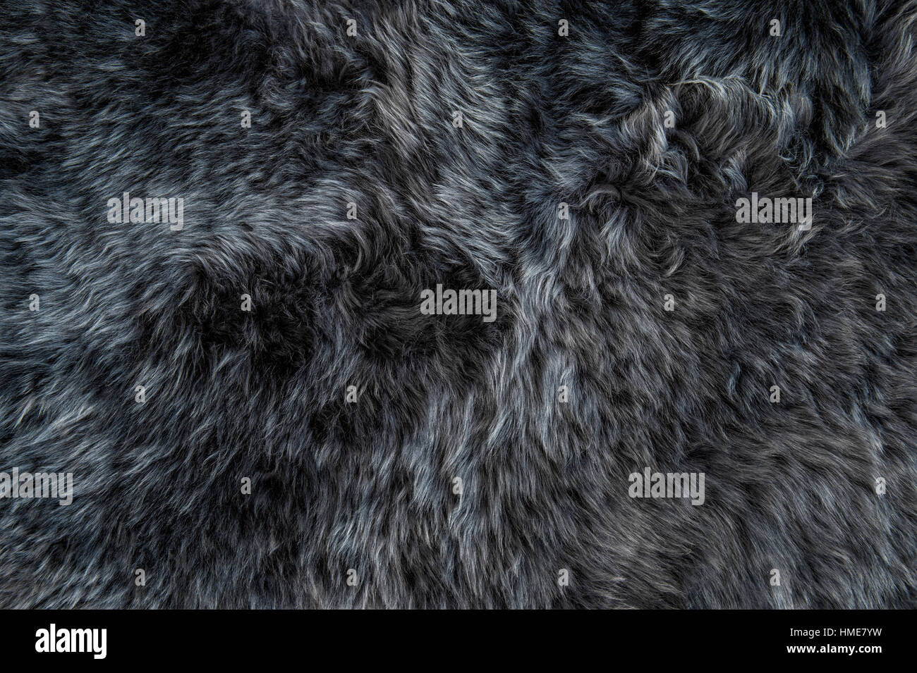 Grey sheepskin rug background. Wool texture. Close up sheep fur Stock Photo