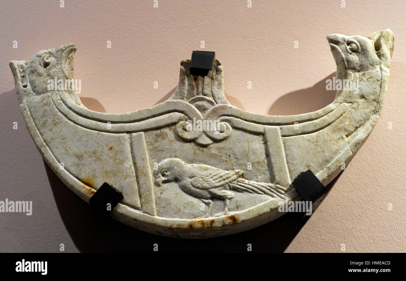 Oscillum shaped as a pelte with griphon-head terminations and with a relief depicting a parrot.  Late 1st century BC. From Pompeii, House of Caecilius Iucundus V 1, 23-26. Marble. National Archeological Museum. Naples. Italy. Stock Photo
