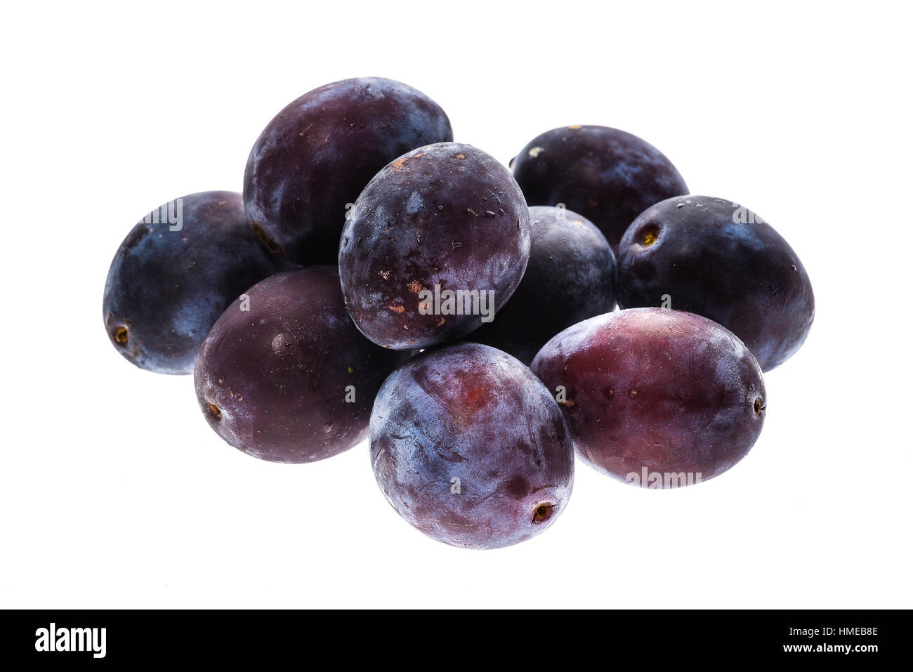 Homegrown organic pile of blue plums isolated on white background
