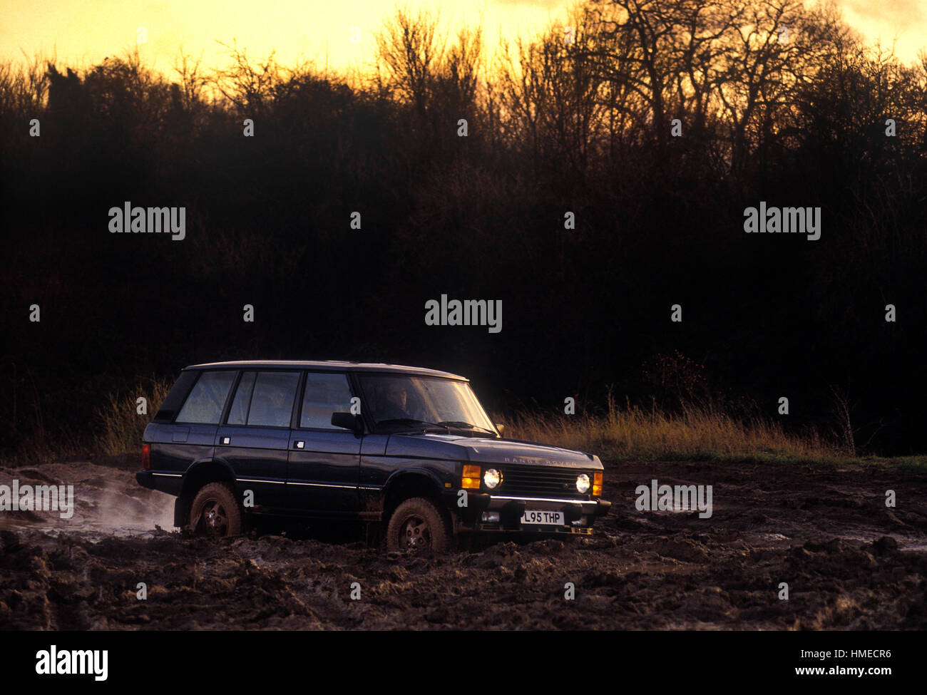 1993 Range Rover driving on muddy track Stock Photo