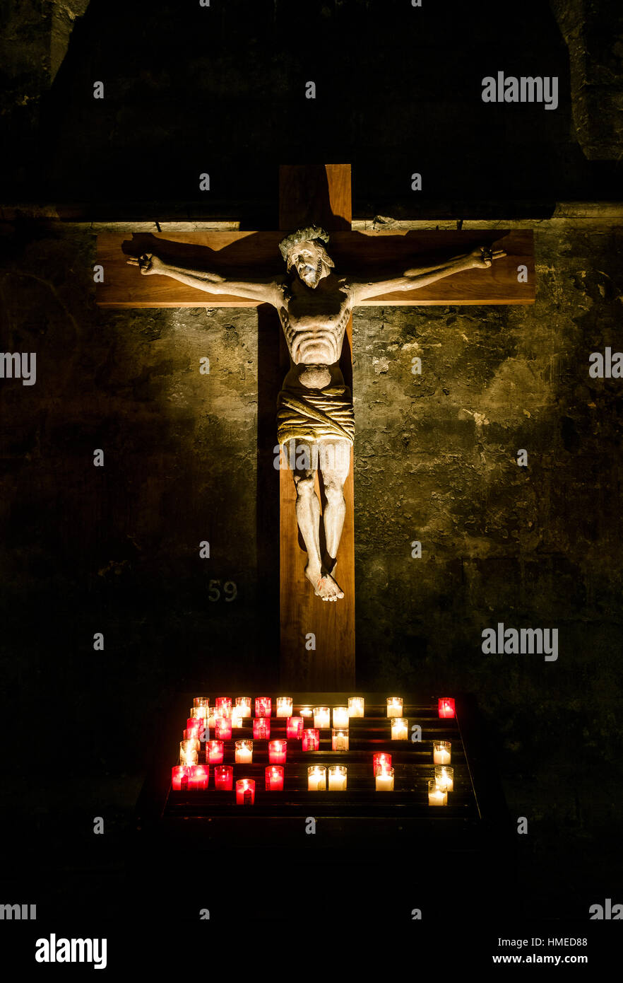 Jesus Christ on the cross lit by candles, Chartres Cathedral in France Stock Photo