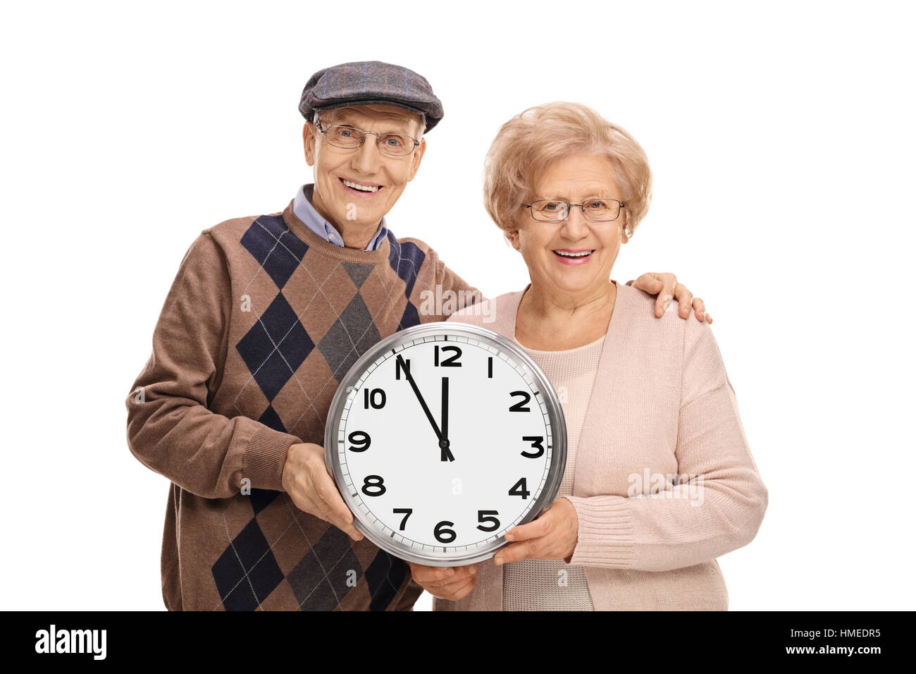 Seniors holding a wall clock isolated on white background Stock Photo