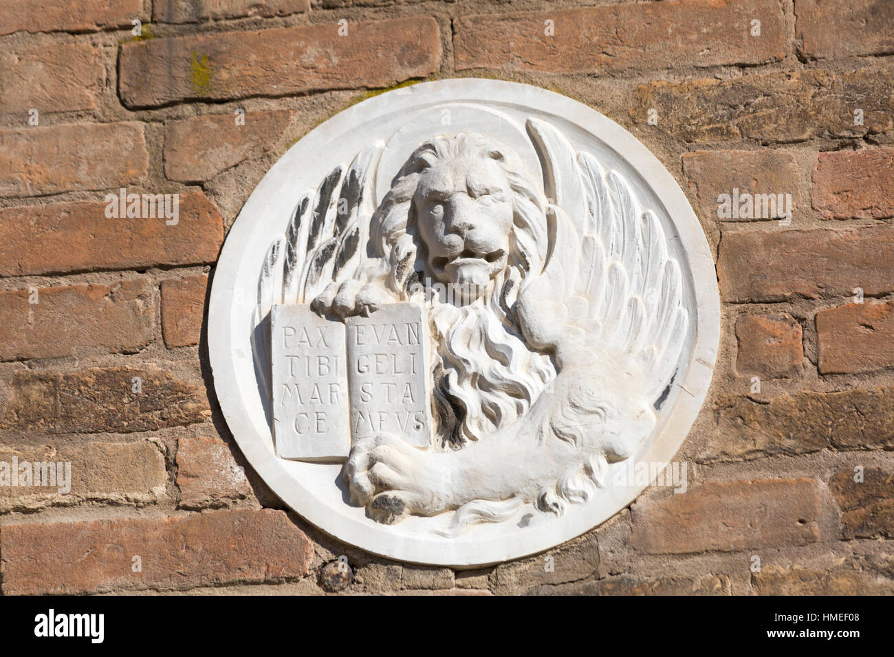 Plaque with winged lion showing the motto of Venice pax tibi mar ce evan geli sta mevs, Peace be upon you O Mark my Evangelist, at Venice, Italy Stock Photo