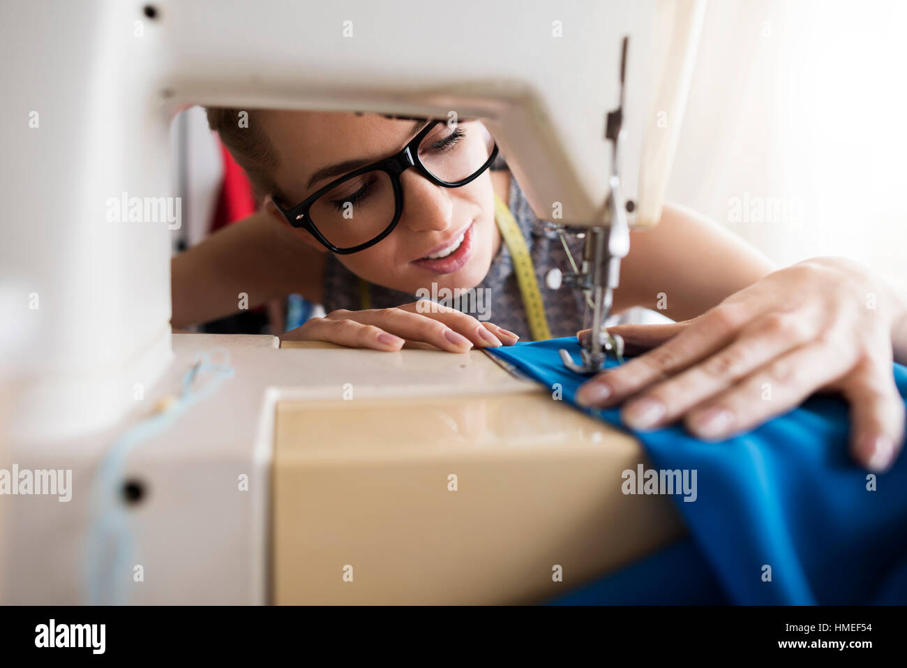 Young tailor working with sewing machine Stock Photo Alamy