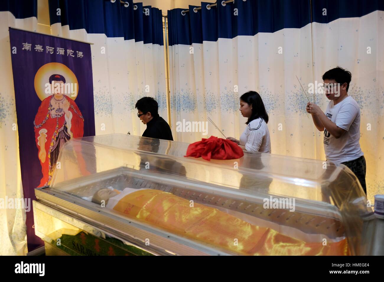 Relatives strolling in circle and prayers for the deceased. Sarawakian chinese funeral ceremony