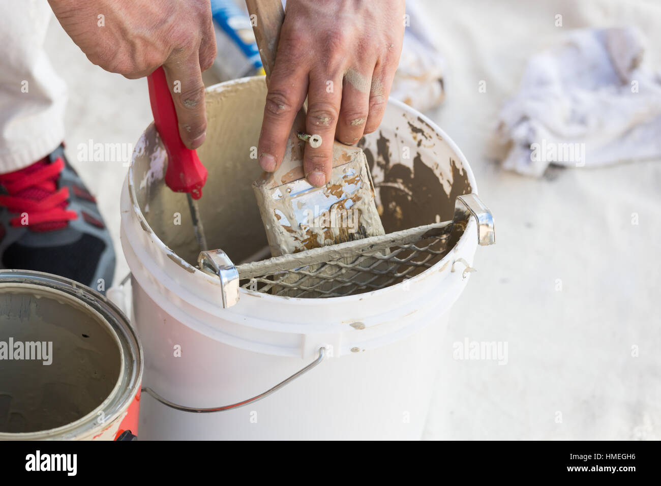 Professional Painter Loading Paint Onto His Brush From A Bucket Stock
