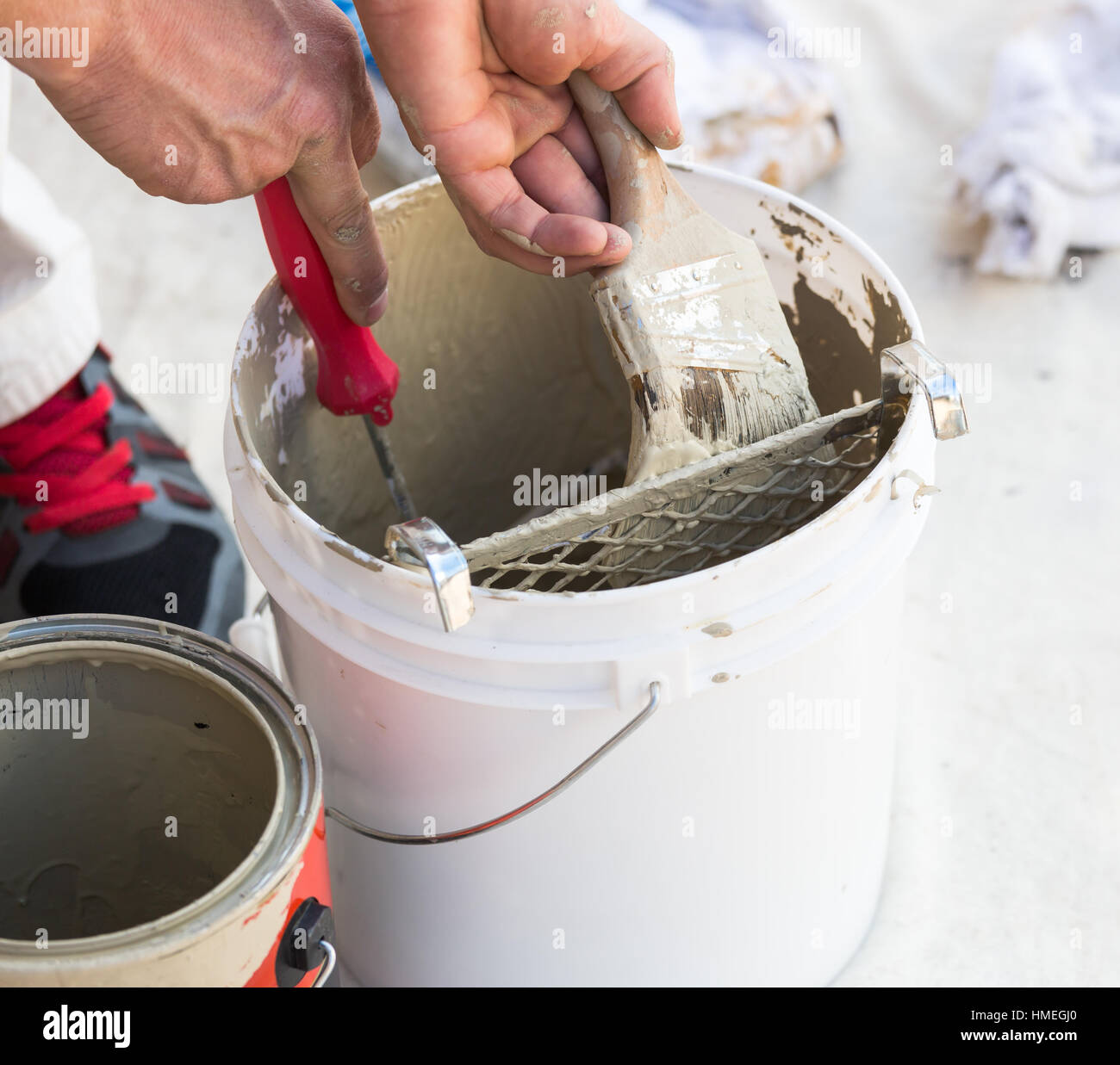 Professional Painter Loading Paint Onto His Brush From A Bucket Stock
