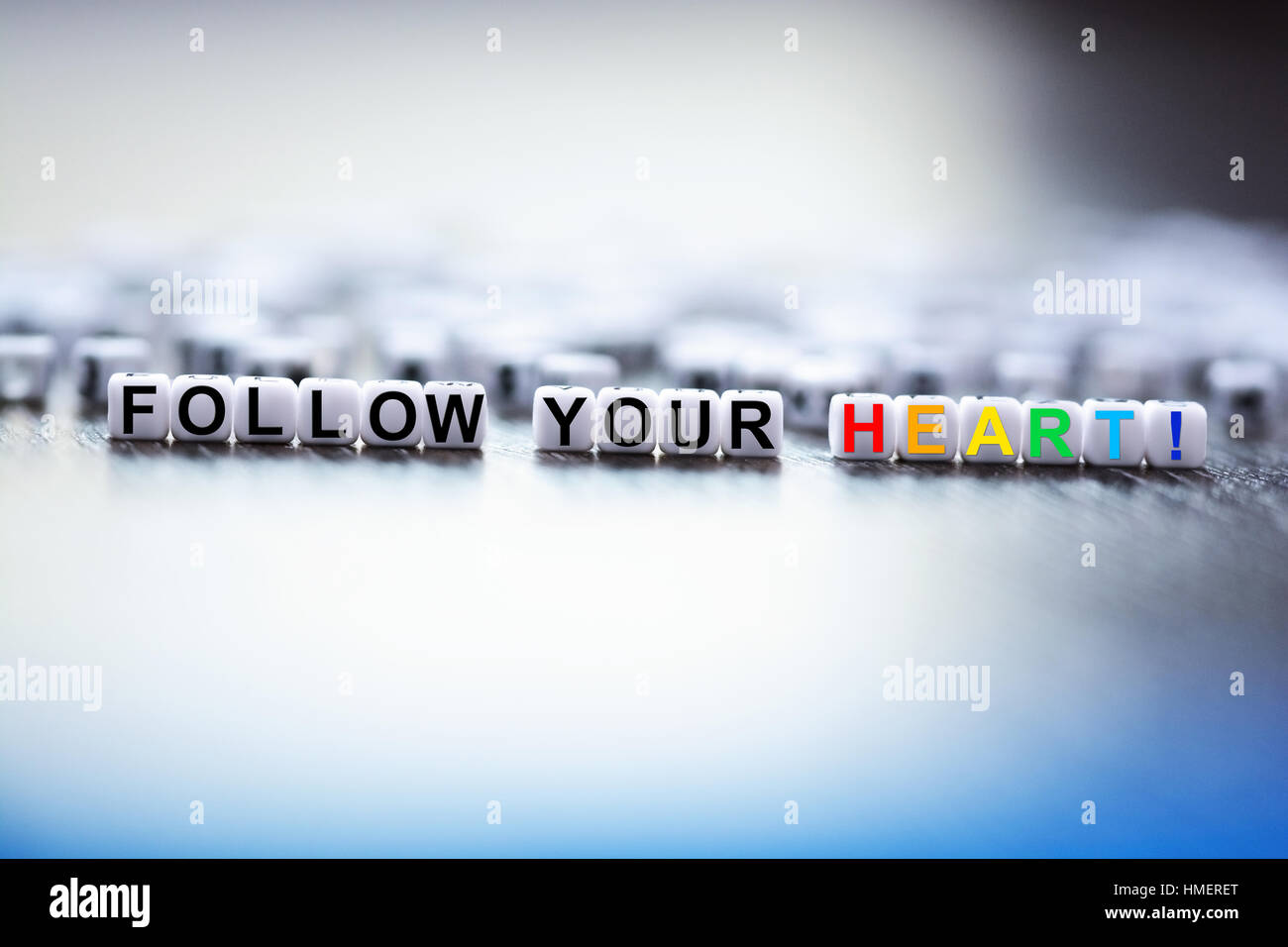 Follow your heart text spelled with plastic letter beads Stock Photo