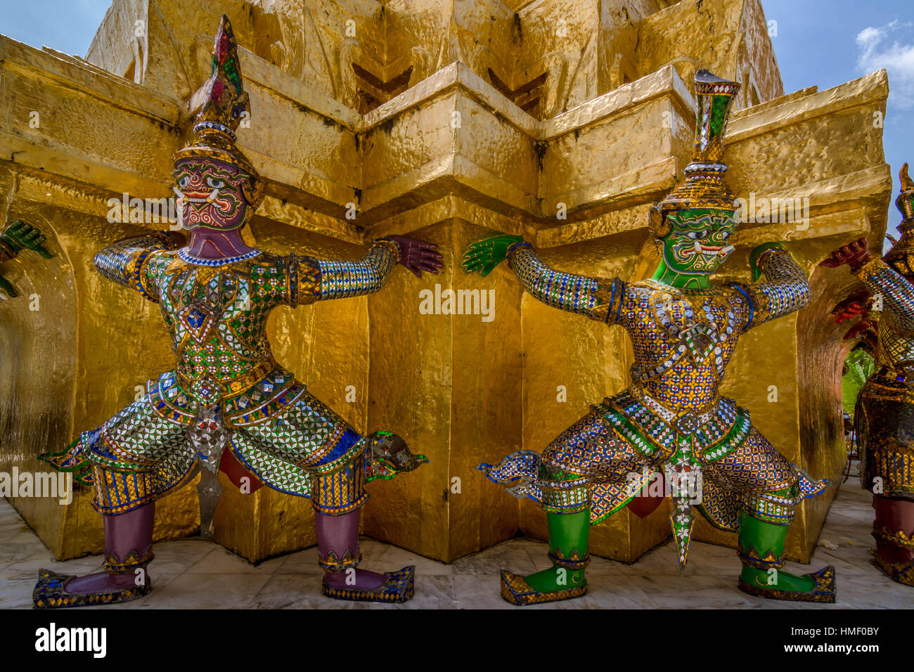 Demons guarding gilded Chedi (Stupa) in Wat Phra Kaew, in Bangkok (Thailand) Stock Photo