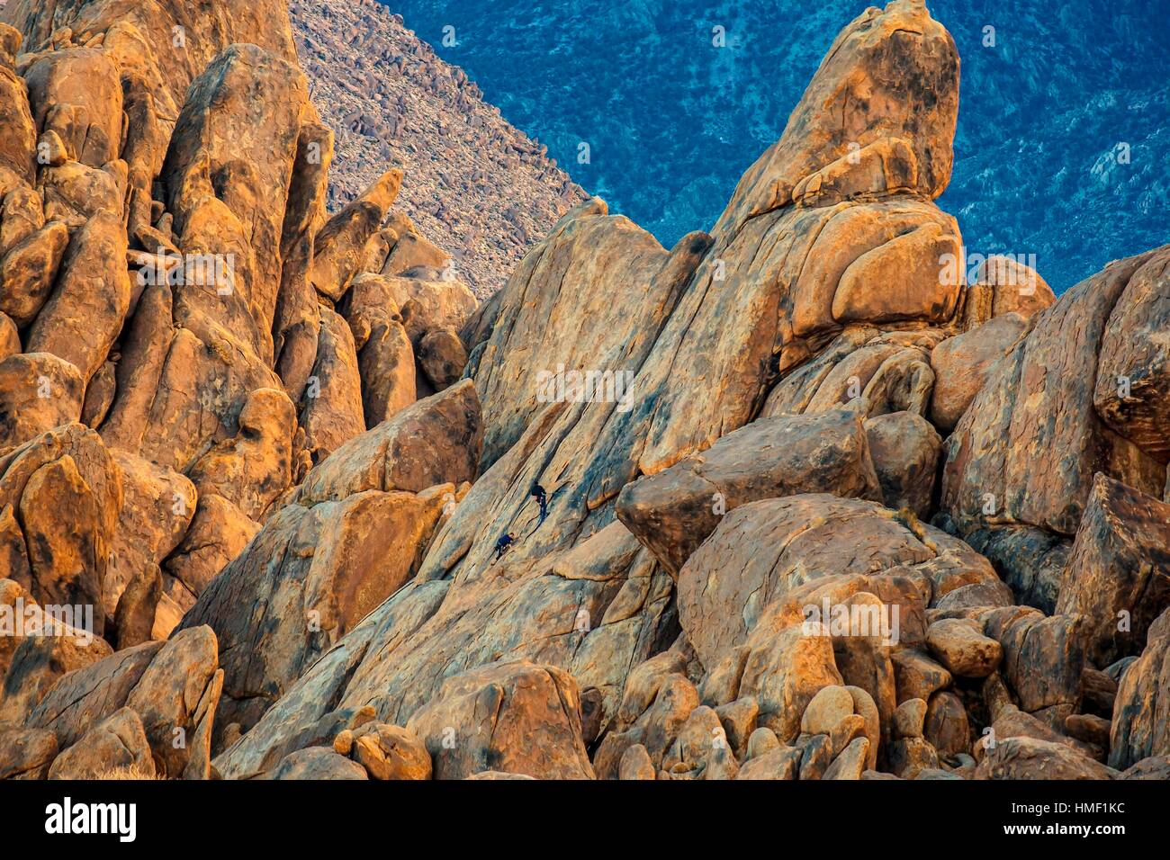 A couple of rock climbers negotiate the steep rock walls at Alabama Hills in the Owens Valley of California. Stock Photo