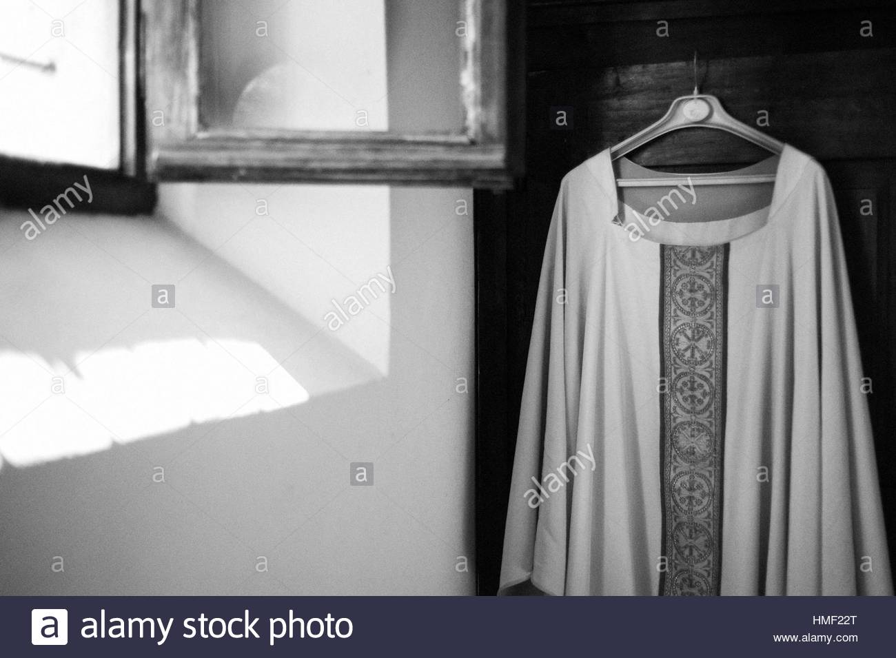 Sacristy Robe Of The Priest Hanging In Wardrobe Stock Photo