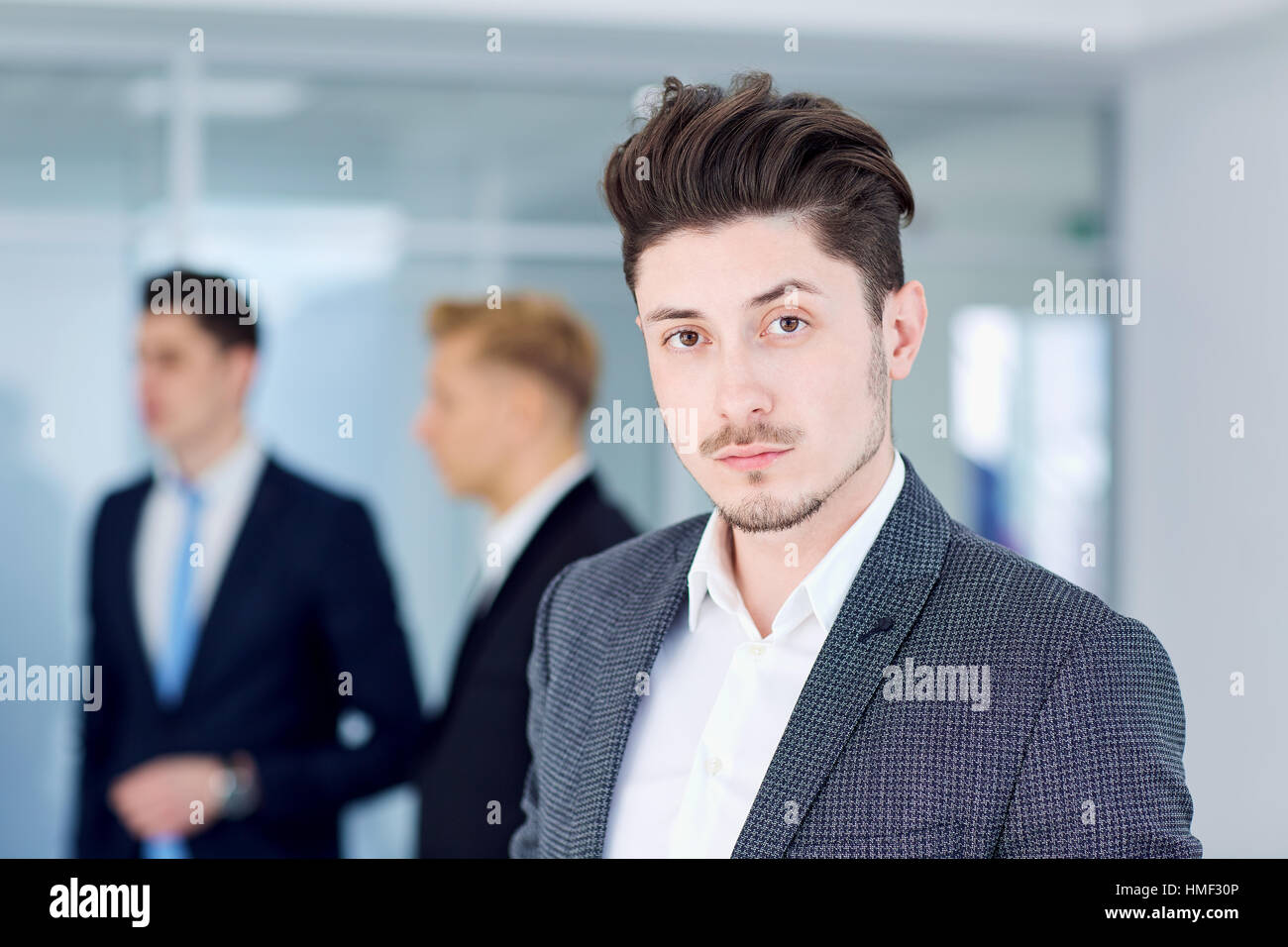 Young businessman  on the background of his business partners Stock Photo