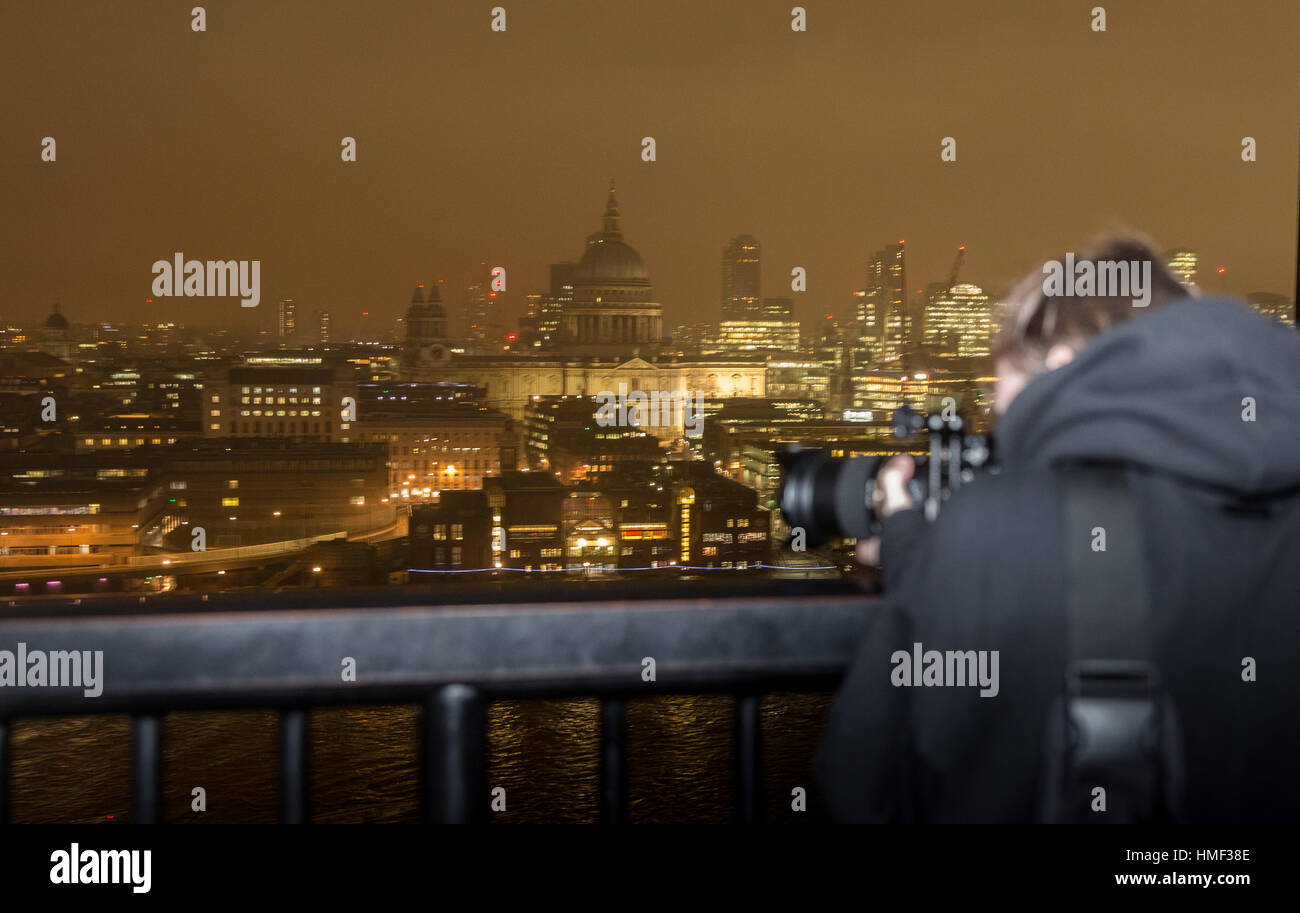 A photographer takes a photograph from the balcony of the Tate Modern Switch House in London Stock Photo
