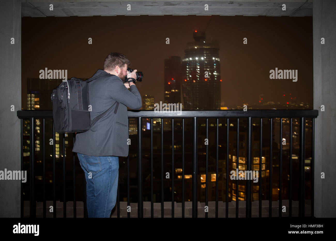 A photographer takes a photograph from the balcony of the Tate Modern Switch House in London Stock Photo