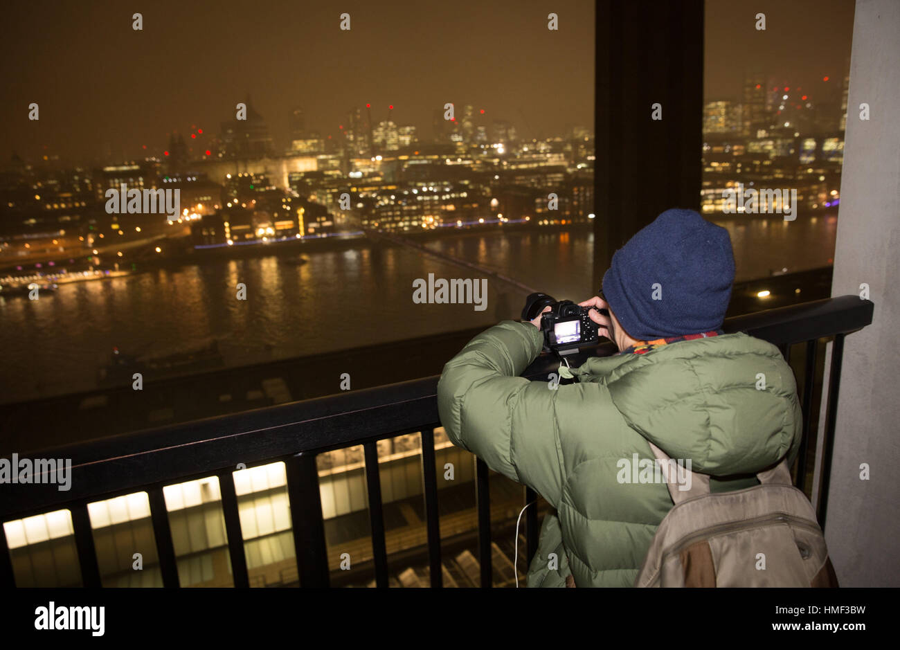 A photographer takes a photograph from the balcony of the Tate Modern Switch House in London Stock Photo