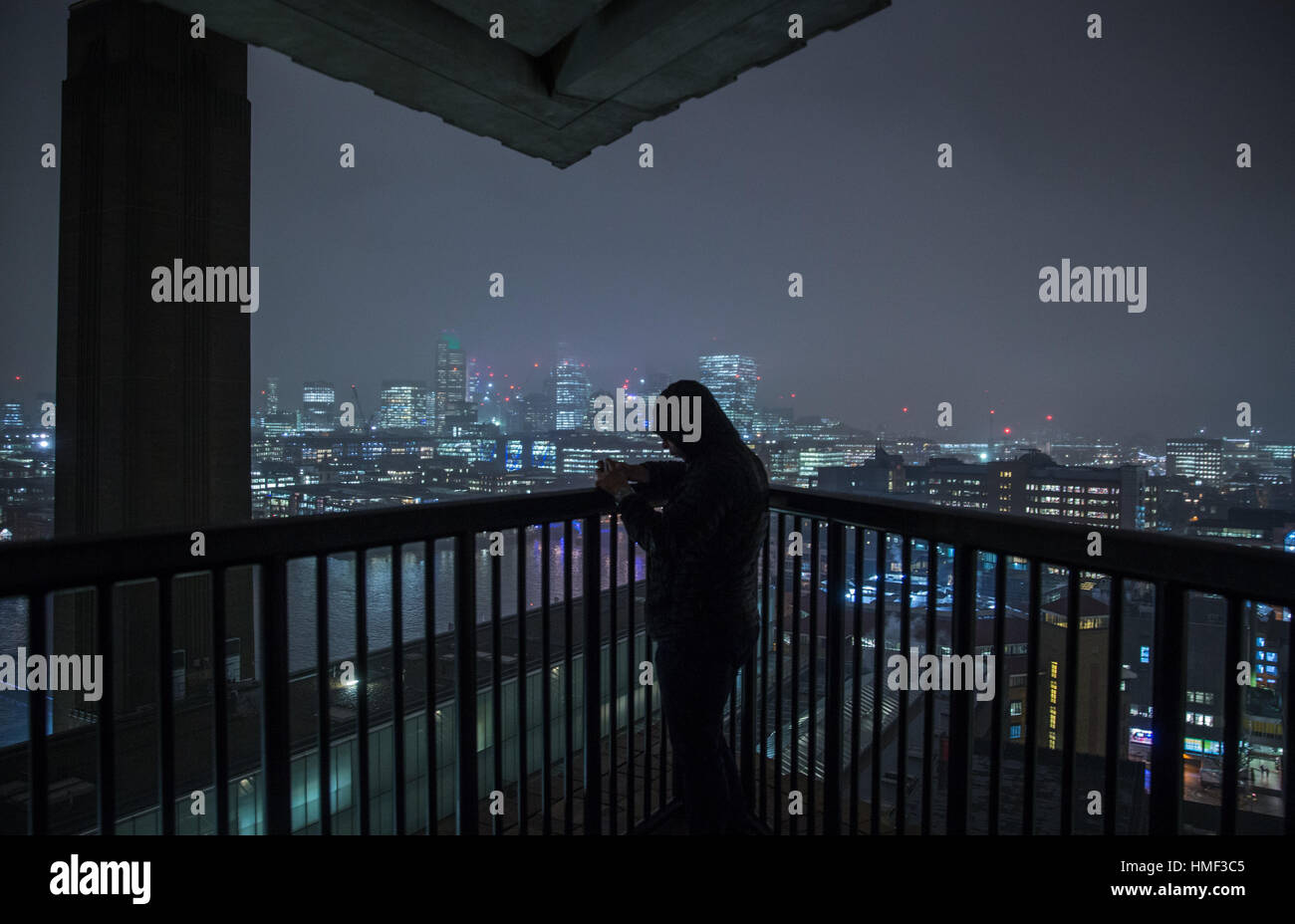 A photographer takes a photograph from the balcony of the Tate Modern Switch House in London Stock Photo