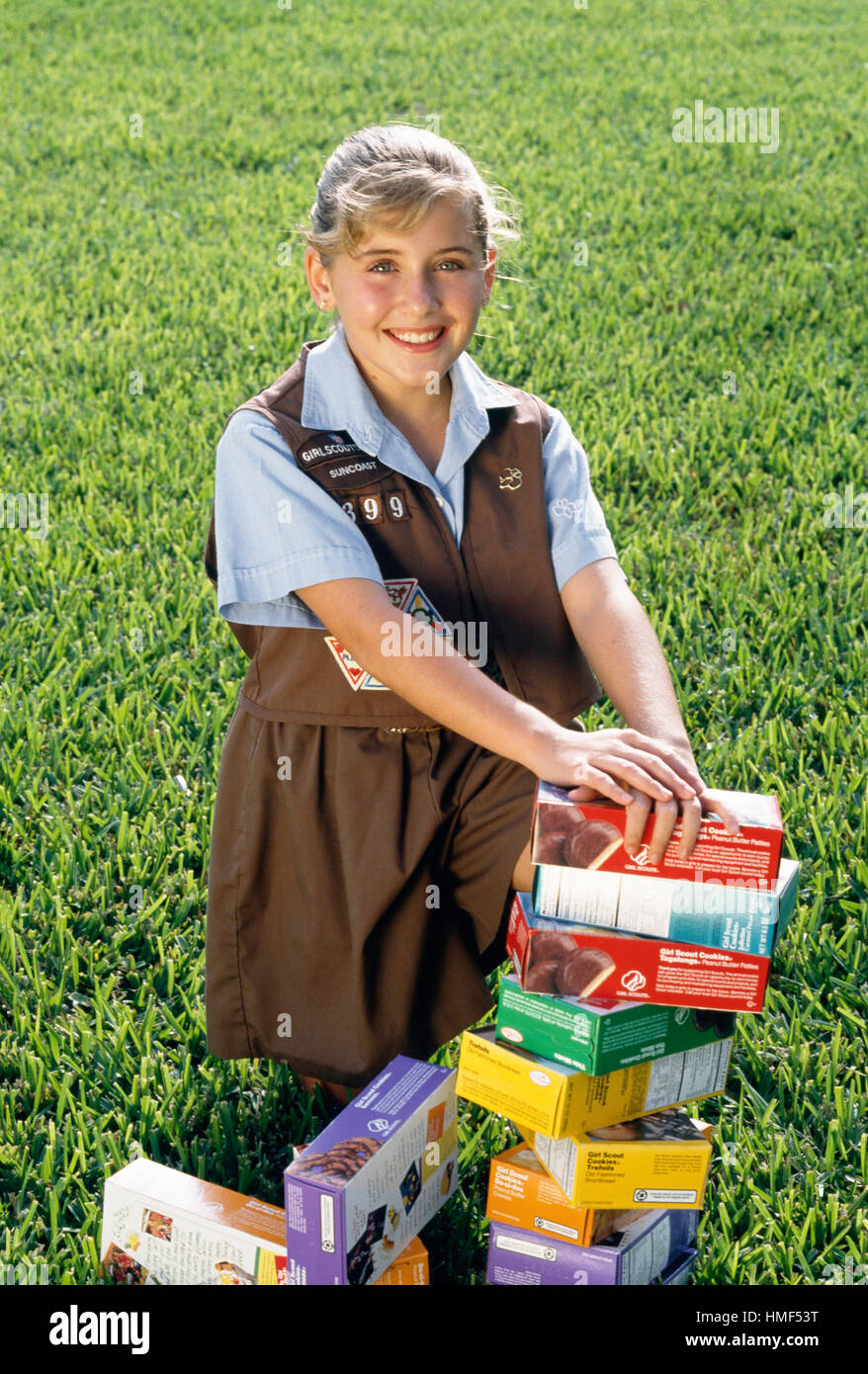 Smiling Young Girl Selling Girl Scout Cookies, USA Stock Photo