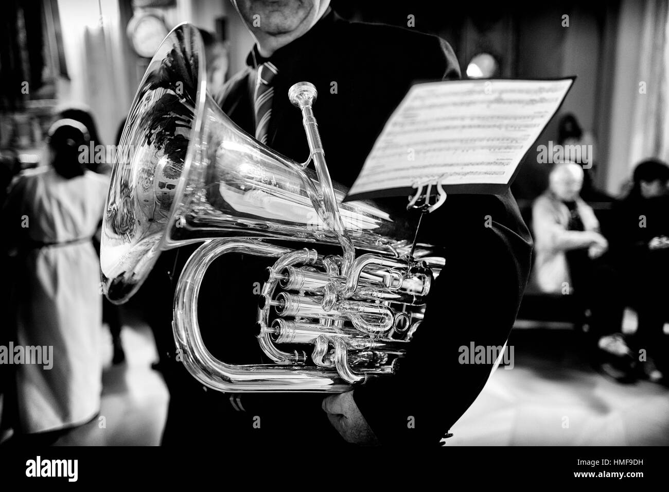 Detail of unrecognizable musician with tubasheet music during Holy Week