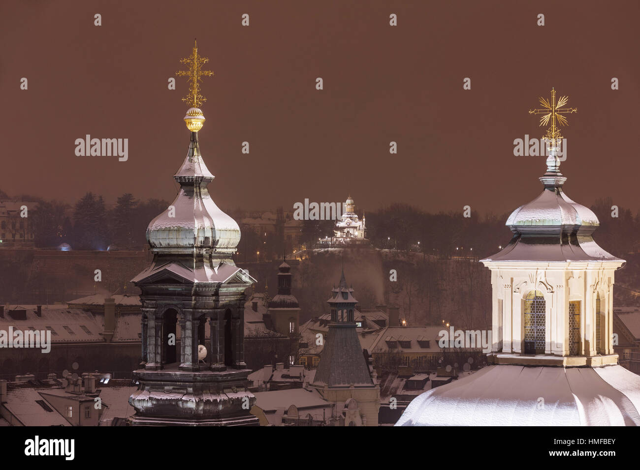 Winter, snowy Prague. View of the snowy towers of the cathedral in the old town. In the distance you can see Hanavsky pavilion Czech Republic Stock Photo
