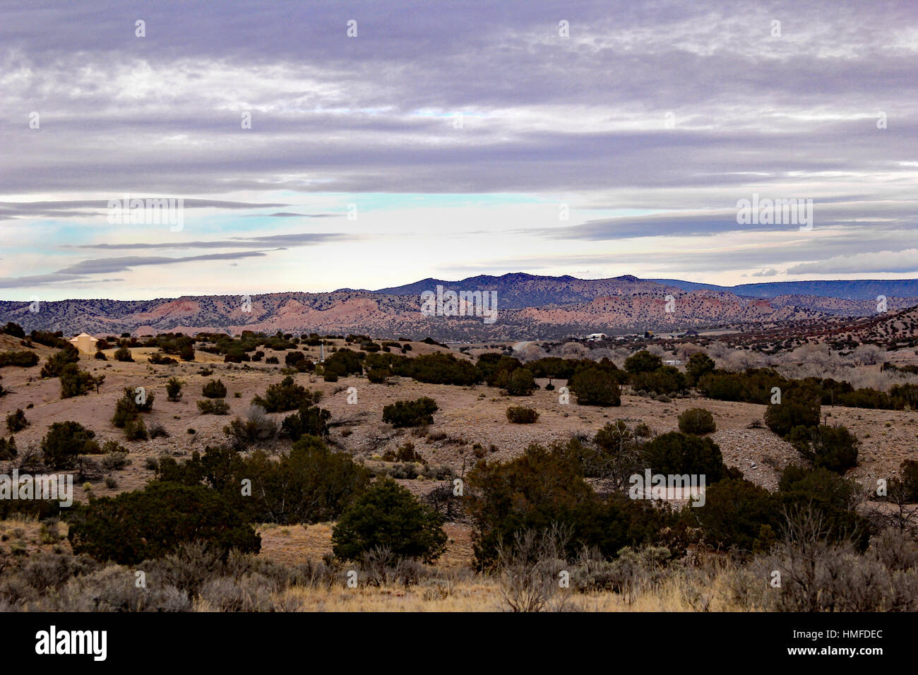 The view atop a backwoods mesa with the mountains in the distance at sunset Stock Photo