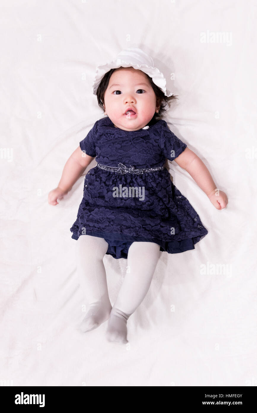 baby girl with cute blue navy dress and white background Stock Photo - Alamy