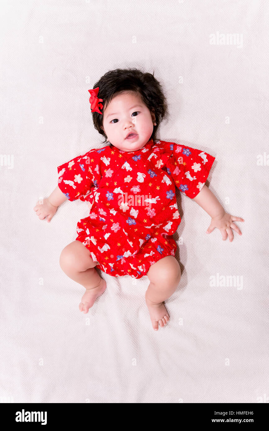 baby girl with cute red Japanese style outfit and white background ...