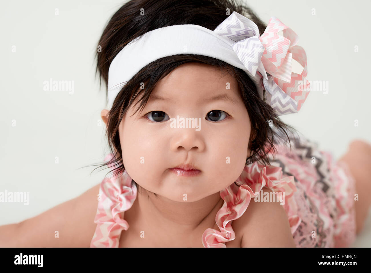 baby girl with cute floral dress and white background Stock Photo - Alamy