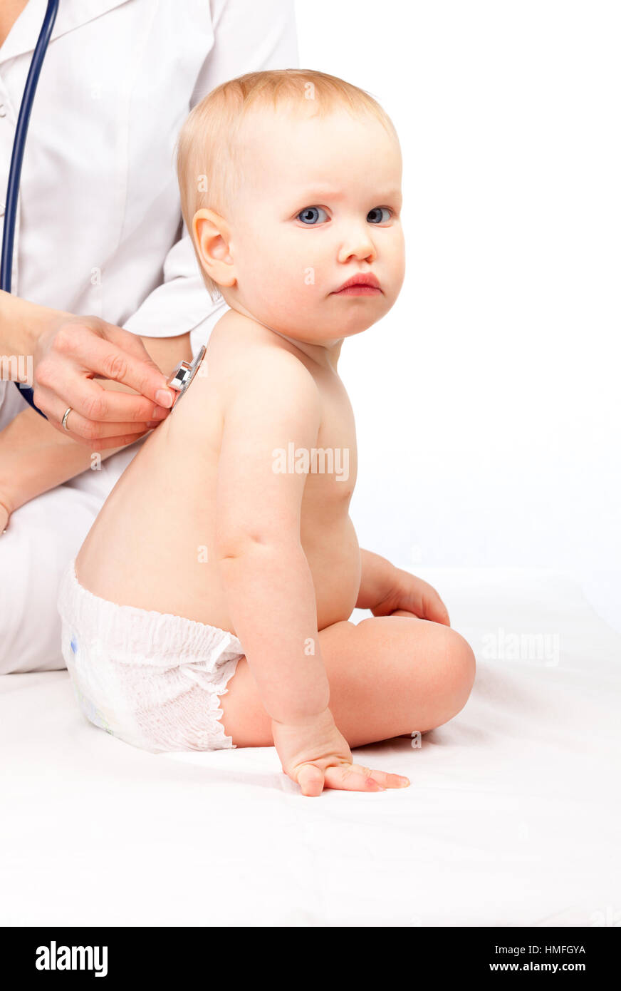 Pediatrician examines little baby girl using a stethoscope to listen to baby's chest checking