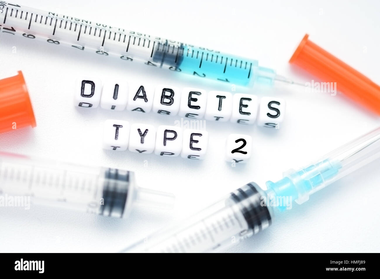 Type 2 diabetes text spelled with plastic letter beads placed next to an insulin syringe Stock Photo