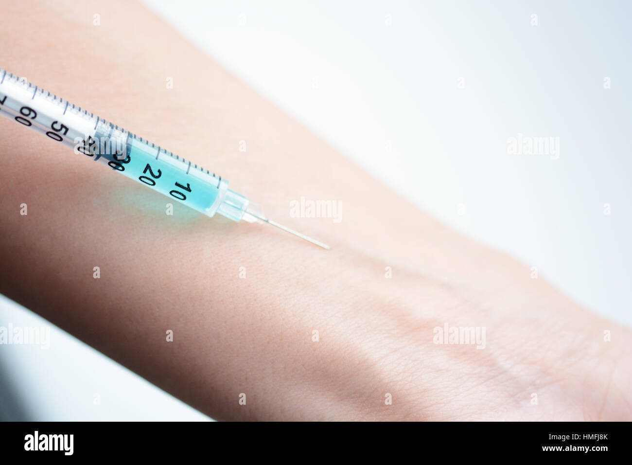 Close-up of a human arm getting an injection Stock Photo