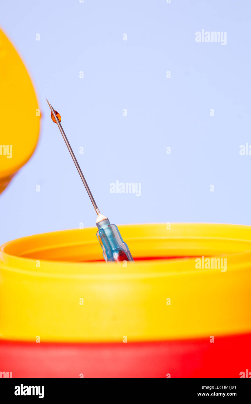 Yellow medical needle disposal waste container, syringe needle with red