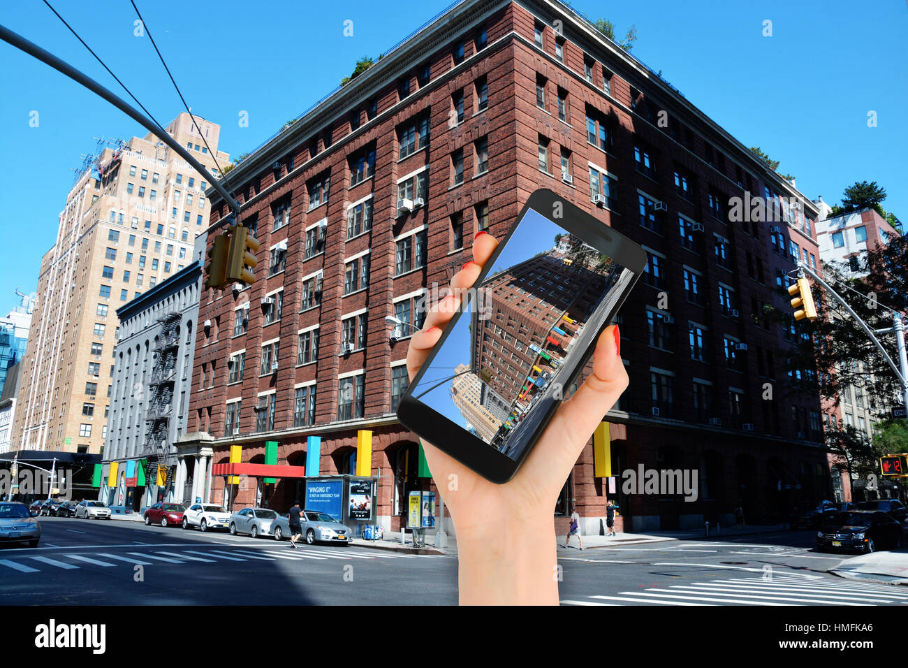 Taking a photo with smartphone at building facades in Manhattan New York City Stock Photo
