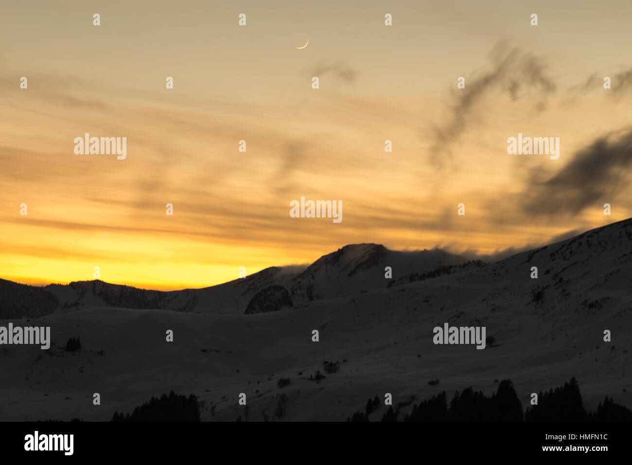 Vibrant orange sunset over snowy mountains in the Alps Stock Photo - Alamy