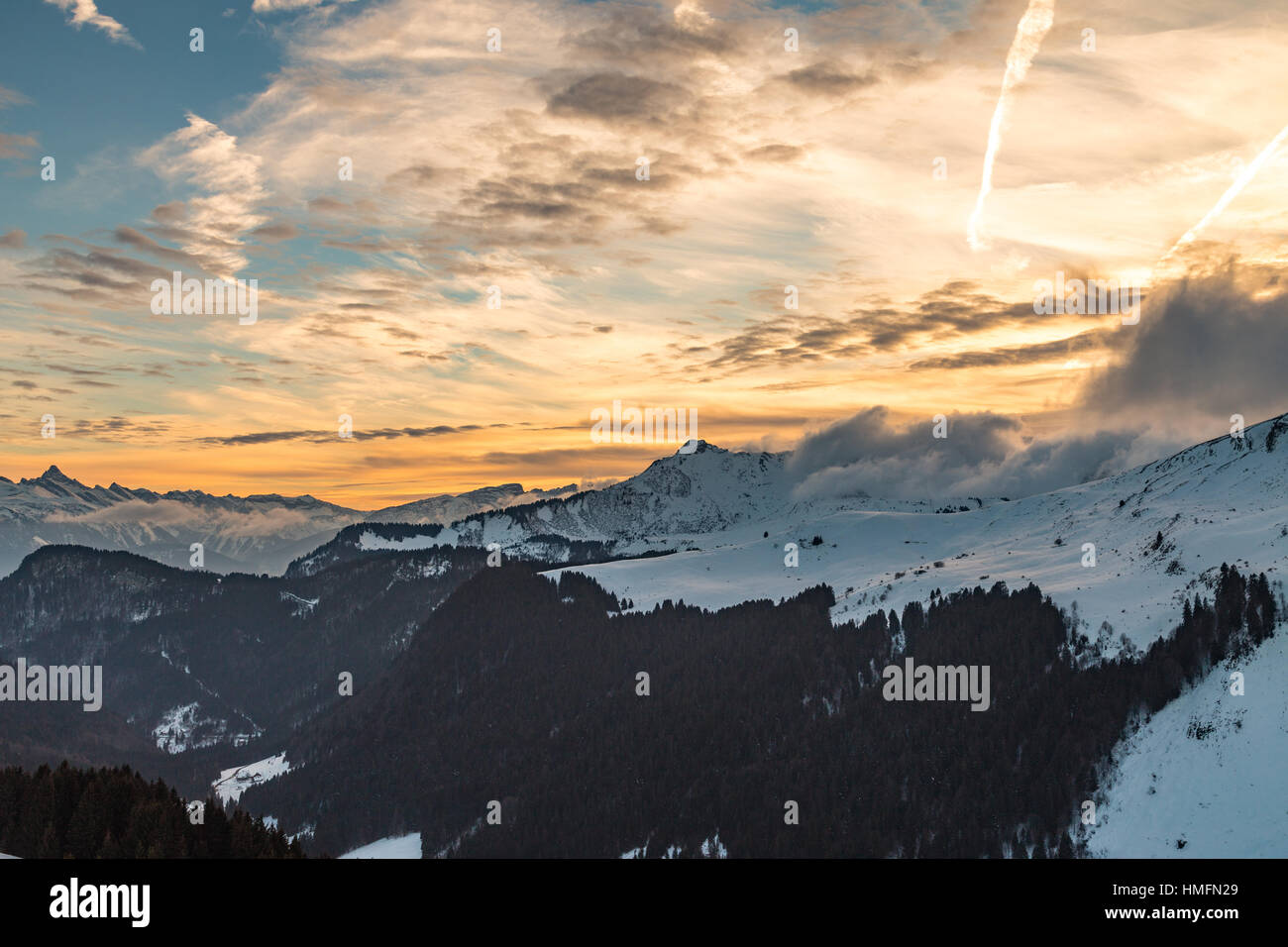 Vibrant orange sunset over snowy mountains in the Alps Stock Photo - Alamy