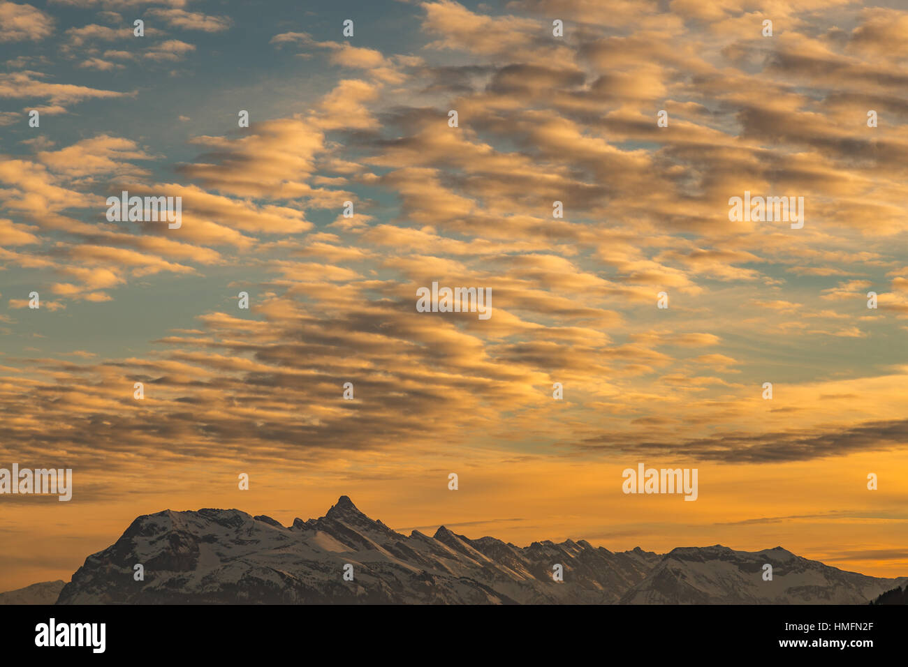 Vibrant orange sunset over snowy mountains in the Alps Stock Photo - Alamy