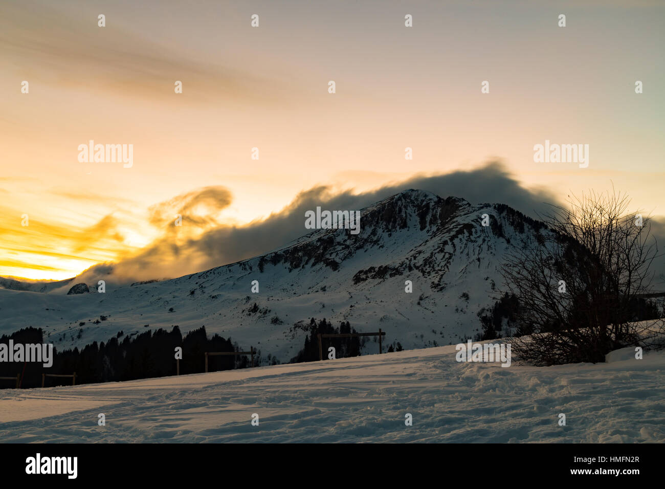 Vibrant orange sunset over snowy mountains in the Alps Stock Photo - Alamy