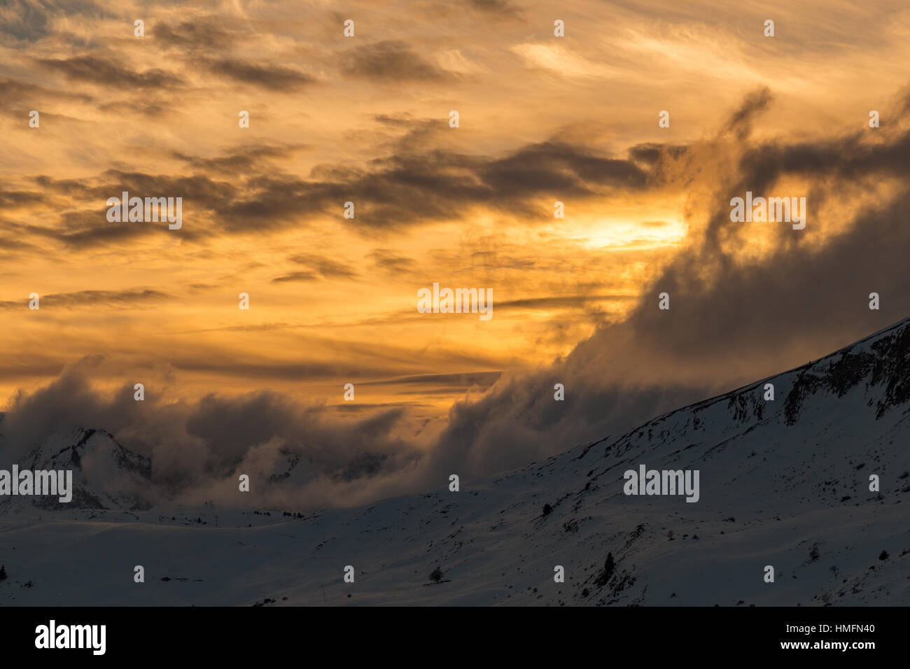 Vibrant orange sunset over snowy mountains in the Alps Stock Photo - Alamy
