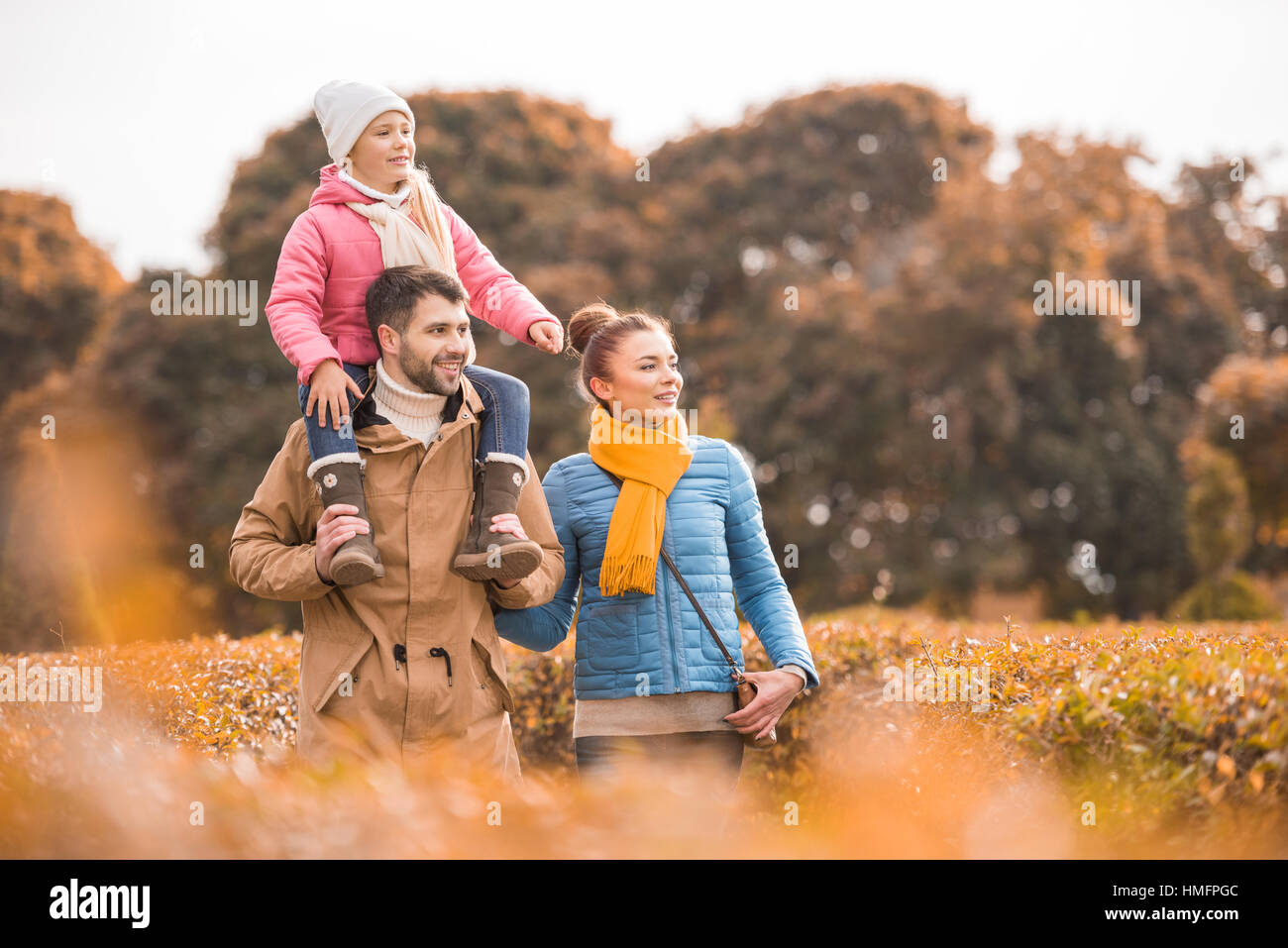 Happy family walking in park Stock Photo - Alamy