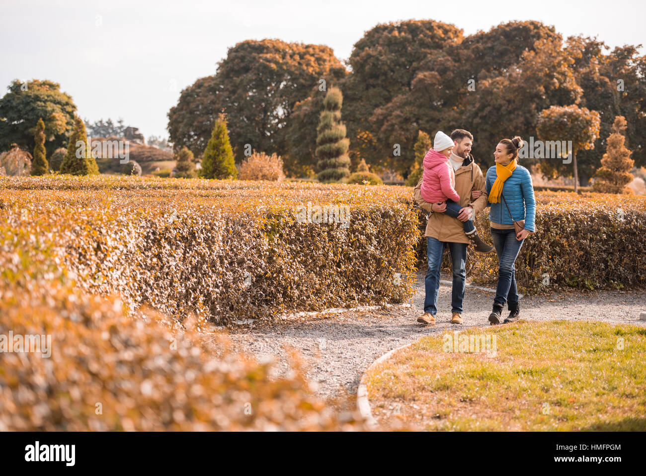 Happy family walking in park Stock Photo - Alamy