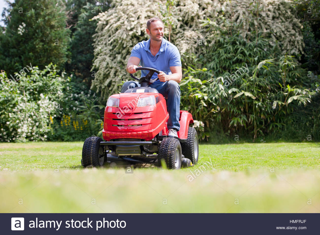 Man Sitting On Lawn Mower Stock Photos & Man Sitting On Lawn Mower ...