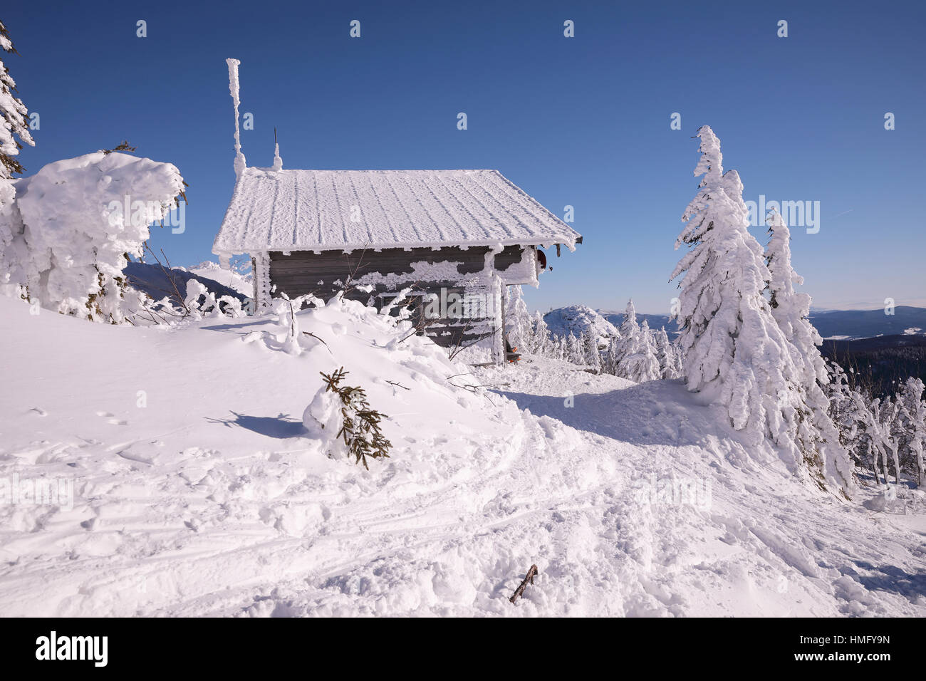 Mountain wooden huts covered with frozen snow. Grosser Arber, Bayerisch Eisenstein, Germany. Winter snowy summit of Mt. Grosser Arber at Bavarian Fore Stock Photo