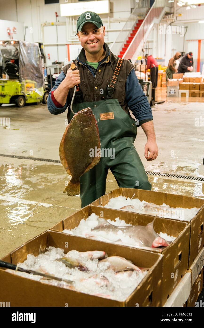 New York City, USA. Wholesale market stall employee proudly presenting